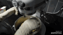 a person is using a kitchenaid mixer to mix something