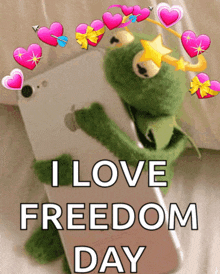 a kermit the frog is holding a phone with the words i love freedom day written on it