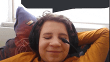 a young boy wearing headphones and a microphone on his face