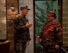 two men in military uniforms are shaking hands