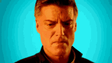a man 's face is shown with a blue background