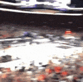 a blurry picture of a crowd of people in a stadium watching a basketball game