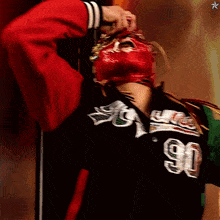 a person wearing a red helmet with the number 90 on it