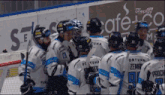 a group of hockey players are huddled together in front of an advertisement for cafe co.