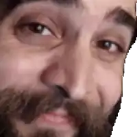 a close up of a man 's face with a beard .