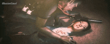 a woman is laying on the floor with a gun in her hand and the words illusive soul on the bottom right