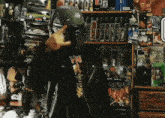 a man wearing a boba fett helmet stands in front of a star wars display
