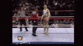 a wrestling ring with a wrestler in a gold suit