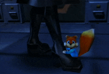 a squirrel is sitting on a person 's foot in a dark room
