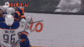 a hockey player with the number 96 on his jersey is fighting another player