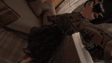 a computer generated image of a girl sitting on a couch giving a peace sign