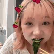 a girl with pink hair has a cherry on her head