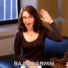 a woman with glasses is waving her hand and the words baaaaanmm are above her