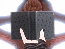 a person holding a book with a pattern of crosses