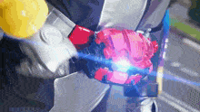 a person in a suit is holding a red and pink object