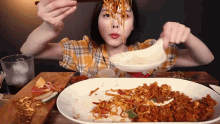 a woman is eating a large plate of food