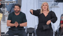 a man and woman are dancing in front of a sign that says " amici "