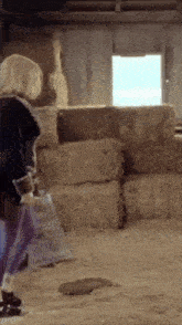 a stack of bales of hay in a barn