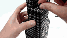 a close up of a person holding a black and silver item
