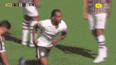 soccer players on a field with a qatar airway ad