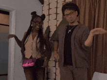 a man and a woman are standing next to each other in a room