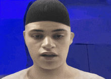a man with a shaved head looks at the camera
