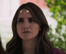 a close up of a woman with a serious look on her face