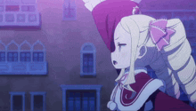 a girl with blonde hair and a pink bow on her head is standing in front of a building