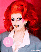 a picture of a drag queen with red hair and a pink bell icon