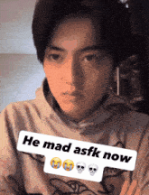 a man wearing a hoodie with the words he mad asfk now