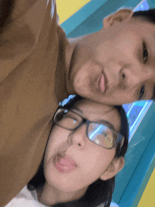 a man and woman with glasses are posing for a picture