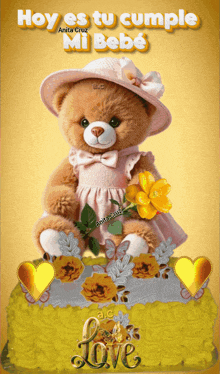 a teddy bear sitting on top of a yellow cake with the words hoy es tu cumple mi bebe