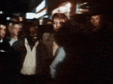 a group of people standing in a dark room