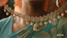 Putting On The Necklace Devi GIF - Putting On The Necklace Devi Maitreyi Ramakrishnan GIFs