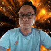a man wearing glasses and a blue shirt has the number 9 on the front of his shirt
