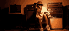 a person sitting in front of a bogner amp