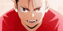 a close up of a person 's face with a red shirt on and a very angry look on their face .
