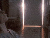a door with a light coming out of it in a room .