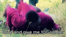 a person laying in the grass with the words drop and give me 100 soldier written below them