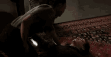a man is laying on the floor with a woman standing next to him .
