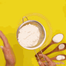 a person is sifting flour into a bowl with easy plus written on the bottom