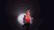 a woman in a red dress is jumping into the air