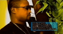 a man wearing sunglasses stands in front of a sign that says werra son fleurid d' amour