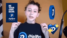 a girl wearing a digibyte shirt stands in front of a sign that says " be your own bank "