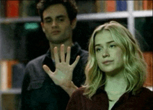 a man and a woman are waving their hands