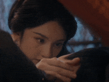 a woman is touching a man 's forehead with her hand