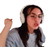 a girl wearing headphones and glasses is making a fist