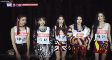 a group of girls are posing for a picture and one of them has a name tag that says ' di ta ' on it