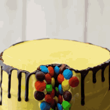 a yellow cake with chocolate and m & m 's on top