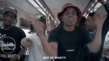 a man wearing a long beach t-shirt is dancing on a bus
